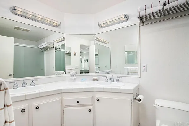 a bathroom with a granite countertop sink mirror and double