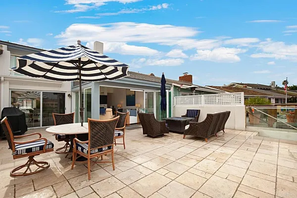 a view of a patio with table and chairs