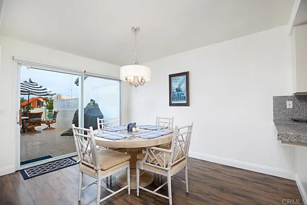 a view of a dining room with furniture wooden floor and chandelier