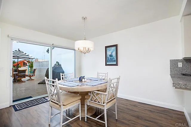 a view of a dining room with furniture wooden floor and chandelier