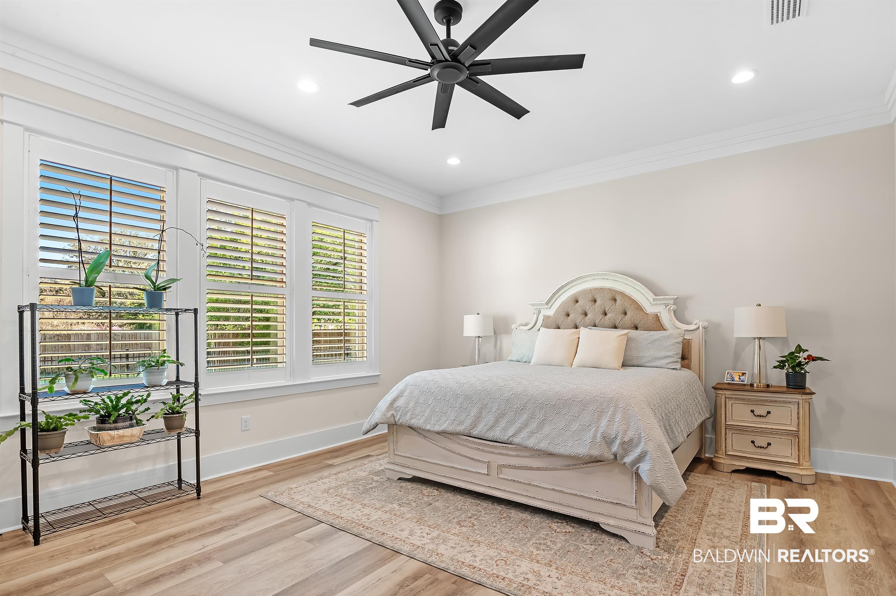 9144 Harvest Ridge Fairhope, AL 36532 - Photo 28 of 58 Bedroom featuring visible vents, baseboards, ornamental molding, wood finished floors, and recessed lighting