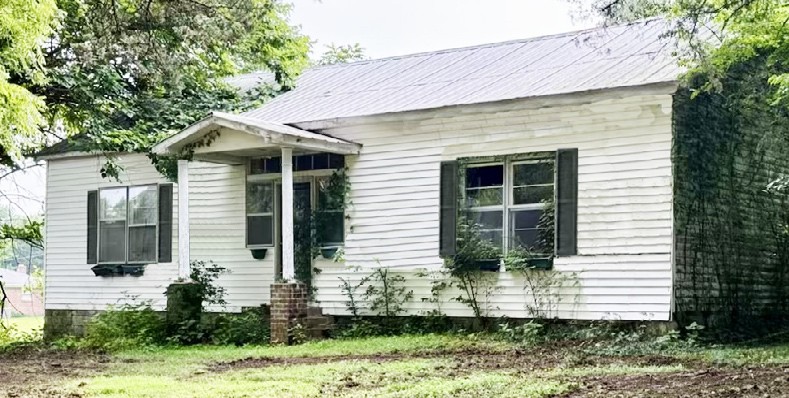 0 Rawls Creek Road Gordonsville, TN 38563 - Photo 5 of 12 a front view of a house with garden