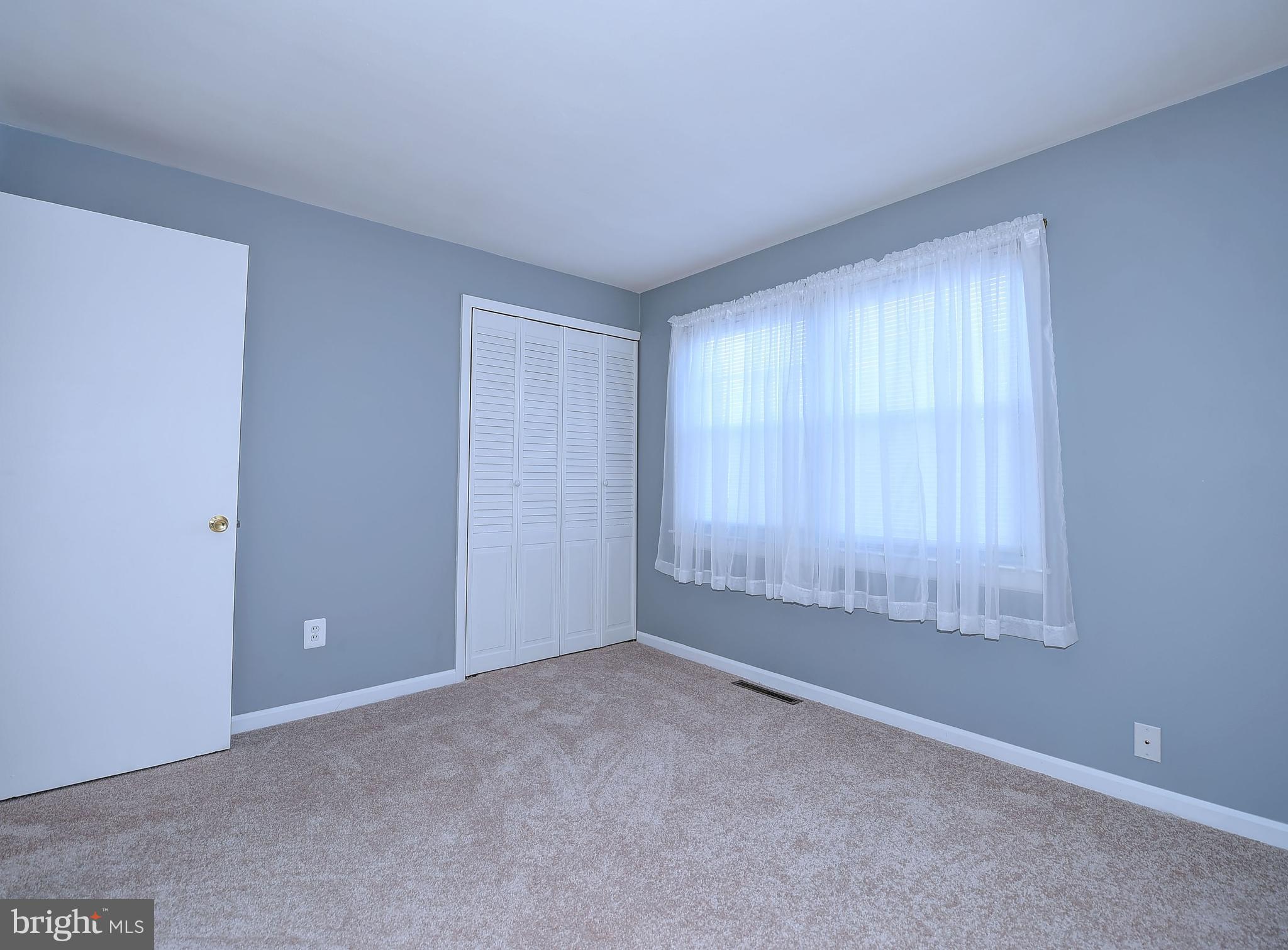 8108 Mid Haven Road Baltimore, MD 21222 - Photo 14 of 28 an empty room with windows and closet