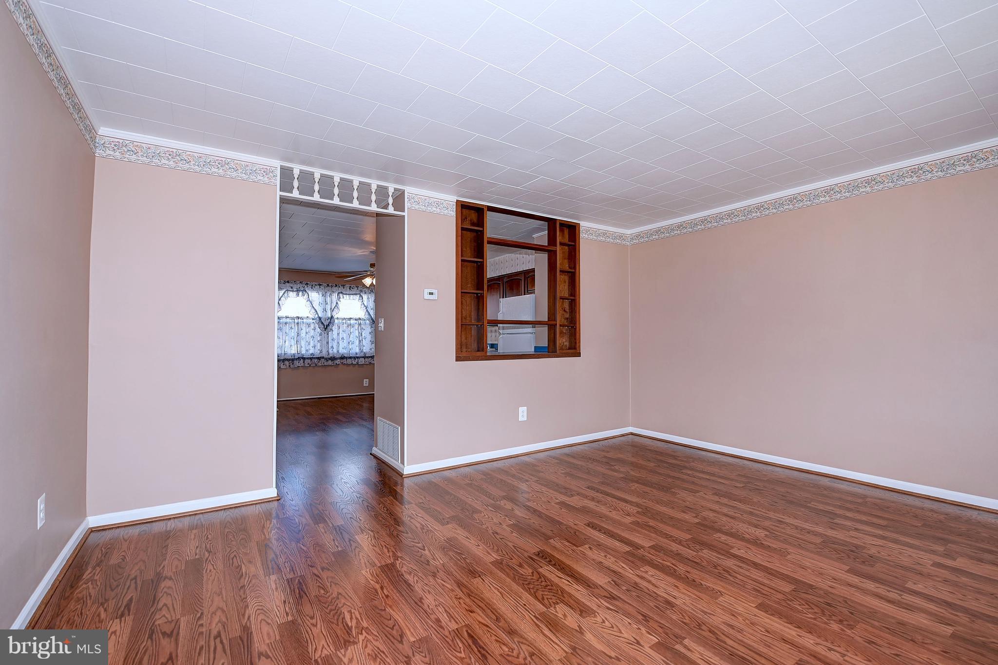 8108 Mid Haven Road Baltimore, MD 21222 - Photo 8 of 28 wooden floor in an empty room with a window