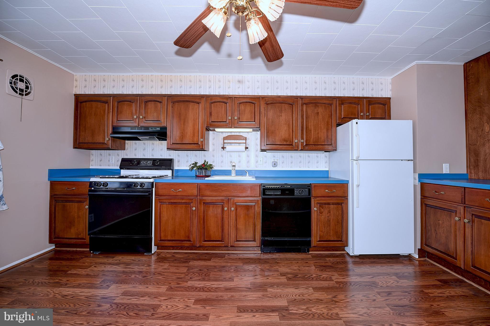 8108 Mid Haven Road Baltimore, MD 21222 - Photo 9 of 28 a kitchen with stainless steel appliances granite countertop a stove top oven a sink and a refrigerator