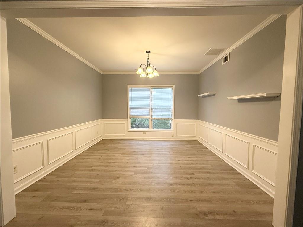 2443 Walnut Tree Lane Buford, GA 30519 - Photo 3 of 15 a view of an empty room with wooden floor and a window
