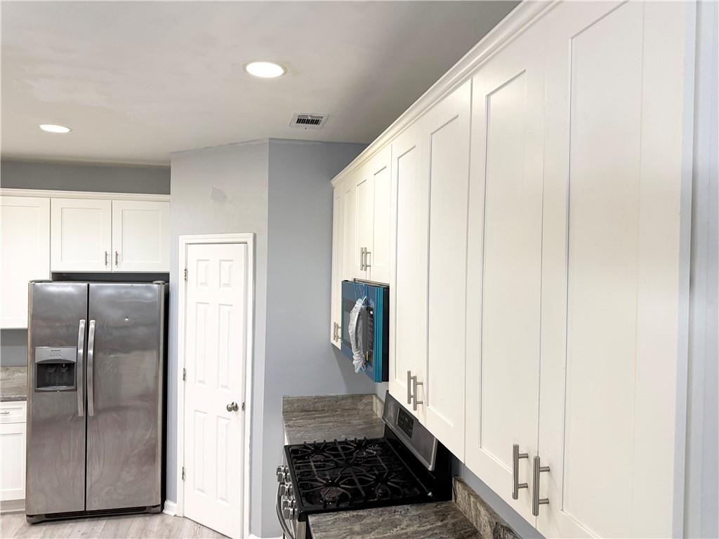 2443 Walnut Tree Lane Buford, GA 30519 - Photo 5 of 15 a kitchen with a refrigerator and cabinets