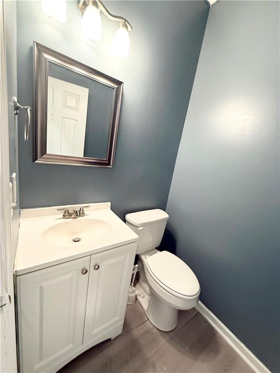 2443 Walnut Tree Lane Buford, GA 30519 - Photo 7 of 15 a white toilet sitting next to a bathroom sink