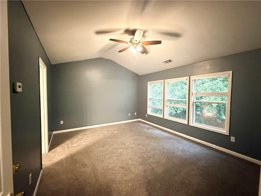 2443 Walnut Tree Lane Buford, GA 30519 - Photo 9 of 15 an empty room with windows and fan