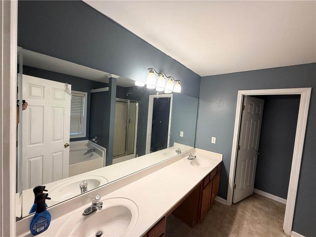 2443 Walnut Tree Lane Buford, GA 30519 - Photo 10 of 15 a bathroom with a sink and a mirror