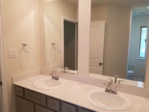 a bathroom with a toilet and shower
