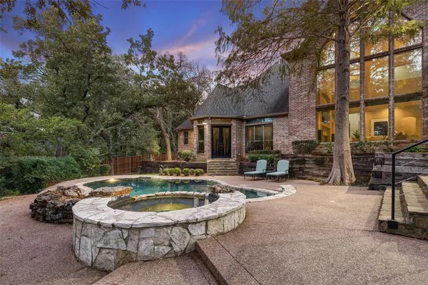 a view of house with swimming pool and sitting area