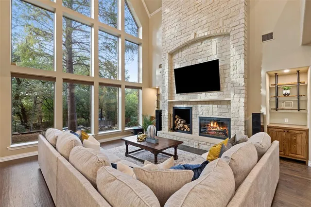 a living room with furniture a fireplace and a flat screen tv