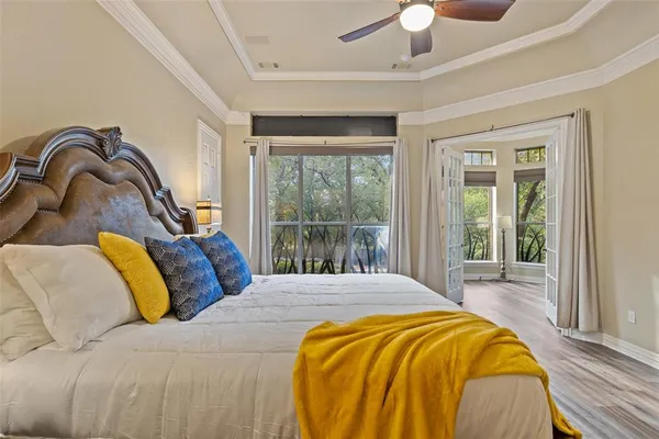 a bedroom with a bed and a large window