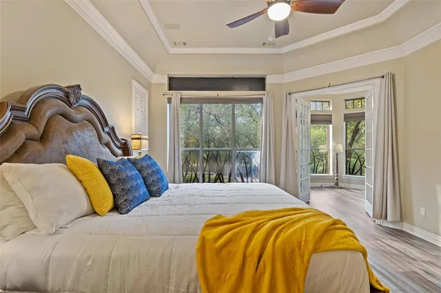 a bedroom with a bed and a large window