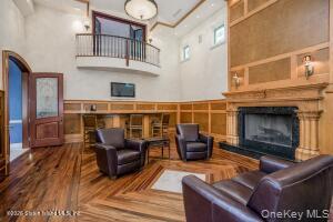 50 Wakefield Staten Island, NY 10312 - Photo 26 of 48 a living room with furniture a fireplace and a wooden floor