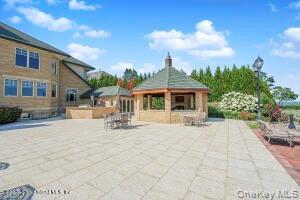 50 Wakefield Staten Island, NY 10312 - Photo 44 of 48 a patio with a table and chairs and potted plants