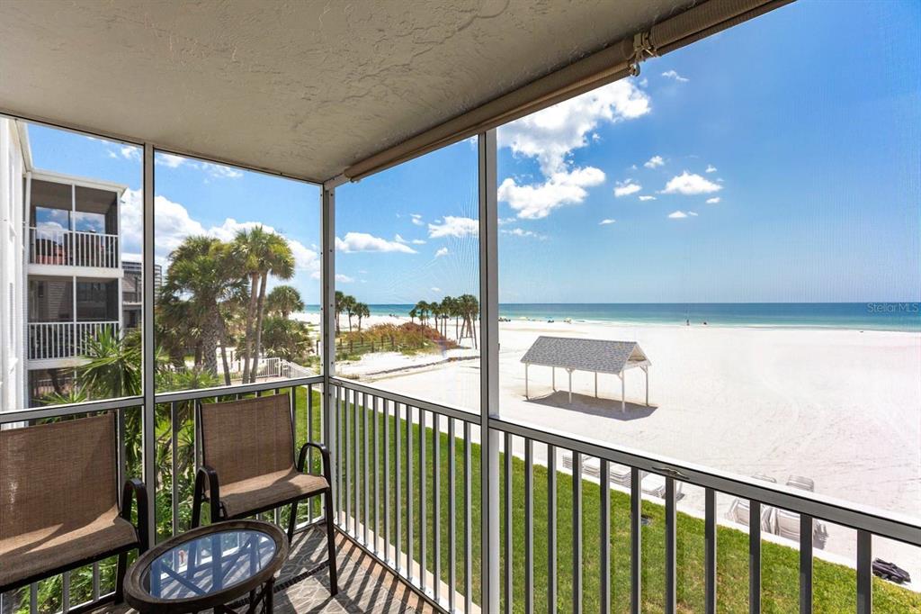 6154 Midnight Pass Road, Unit 202 Sarasota, FL 34242 - Photo 12 of 26 a view of a chair and tables in the balcony