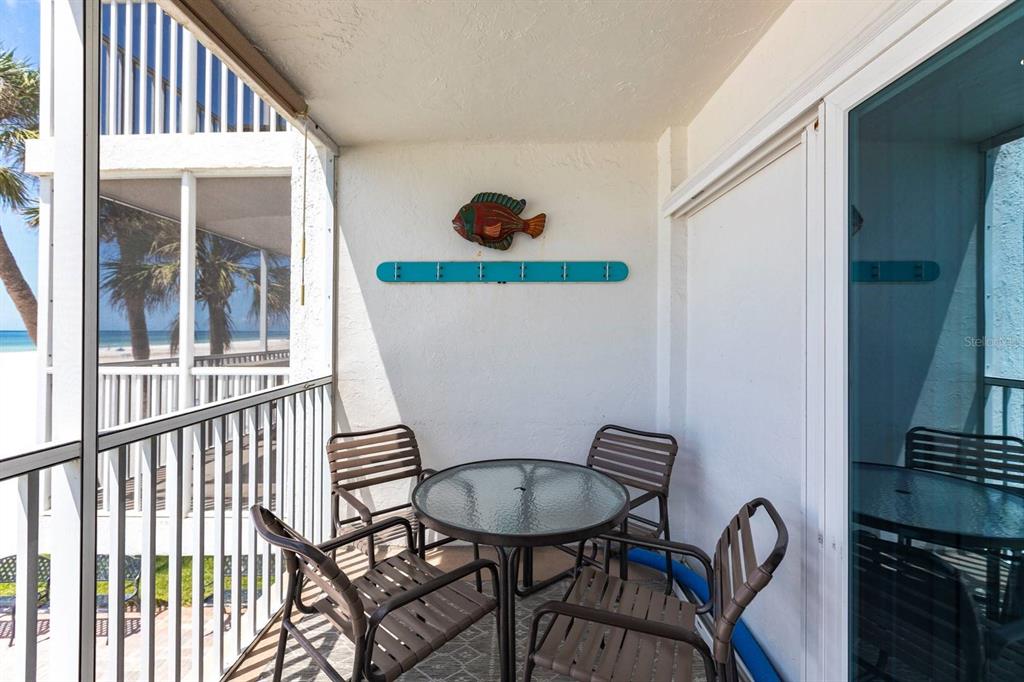 6154 Midnight Pass Road, Unit 202 Sarasota, FL 34242 - Photo 18 of 26 a view of a balcony and dining area