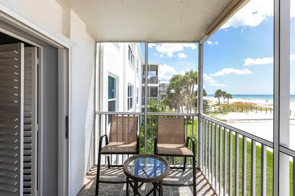 a view of a chairs and table in a balcony