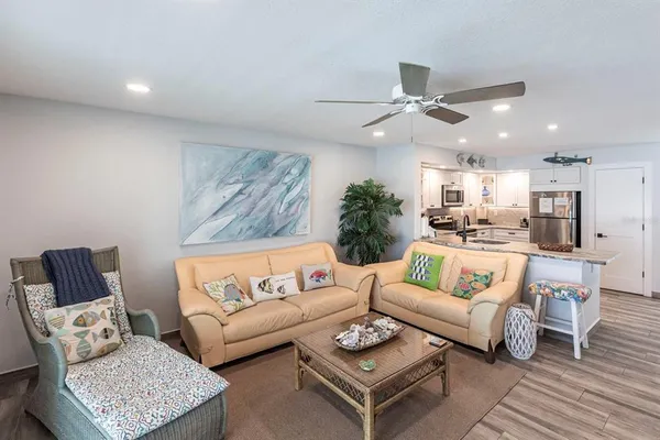 a living room with furniture and a ceiling fan