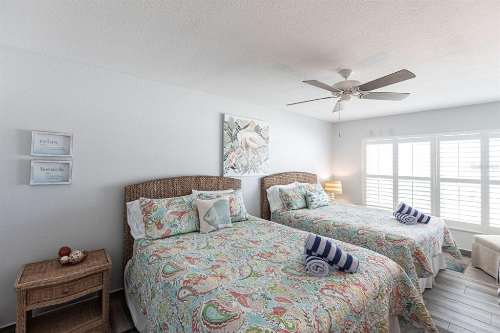 6154 Midnight Pass Road, Unit 202 Sarasota, FL 34242 - Photo 22 of 26 a bedroom with a bed and a window