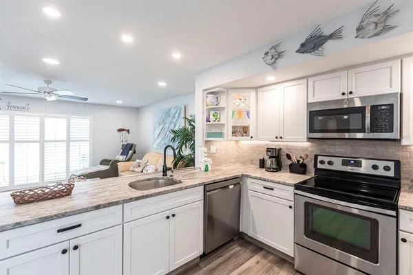 a kitchen with a sink stove and microwave