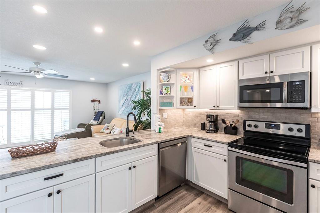 6154 Midnight Pass Road, Unit 202 Sarasota, FL 34242 - Photo 26 of 26 a kitchen with a sink stove and microwave