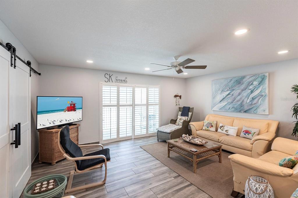 6154 Midnight Pass Road, Unit 202 Sarasota, FL 34242 - Photo 3 of 26 a living room with furniture a rug and a window