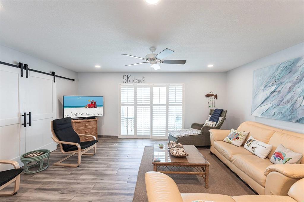 6154 Midnight Pass Road, Unit 202 Sarasota, FL 34242 - Photo 5 of 26 a living room with furniture and a window
