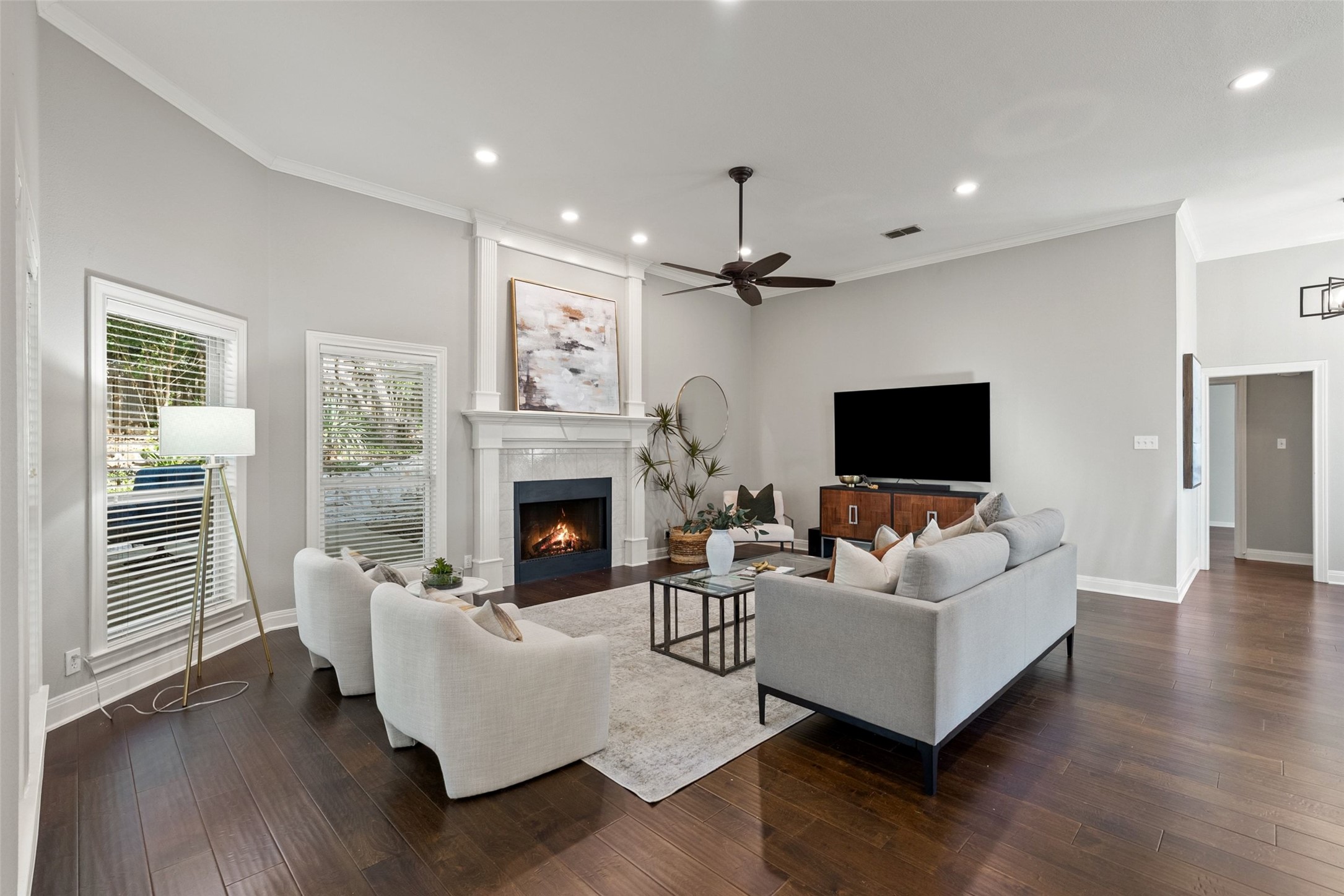 120 Copperleaf Road Lakeway, TX 78734 - Photo 6 of 30 Hardwood floors complement a cozy fireplace, offering inviting ambiance in this family room.