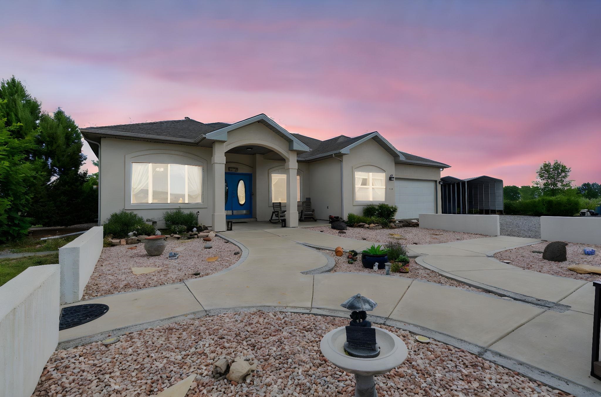 a view of a house with backyard and sitting area