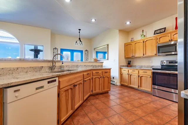 a kitchen with stainless steel appliances granite countertop a stove and a sink