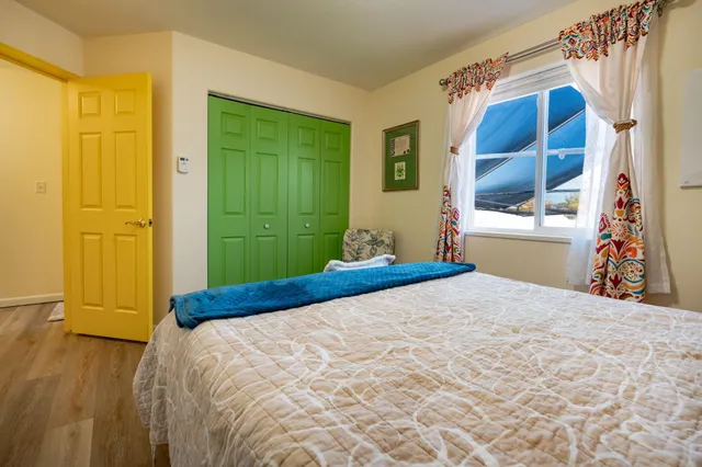 a bedroom with a bed and a window