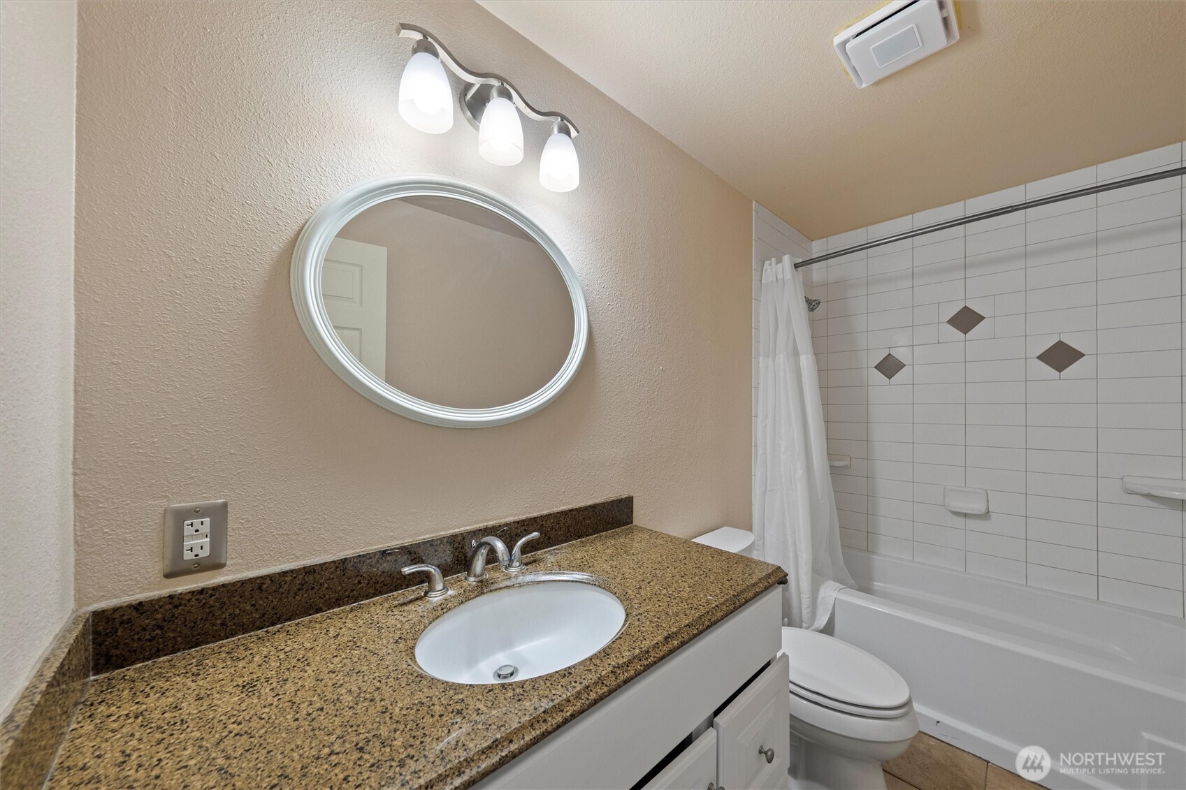 1411 D Street Southwest Ephrata, WA 98823 - Photo 12 of 39 a bathroom with a granite countertop toilet a sink and a mirror
