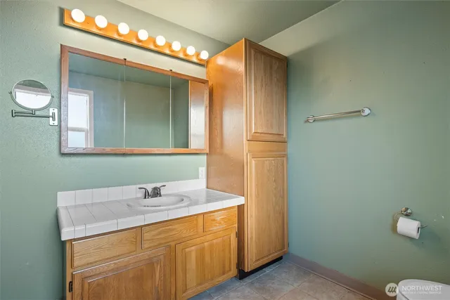 a bathroom with a sink and a mirror