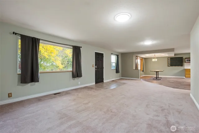 an empty room with windows and closet