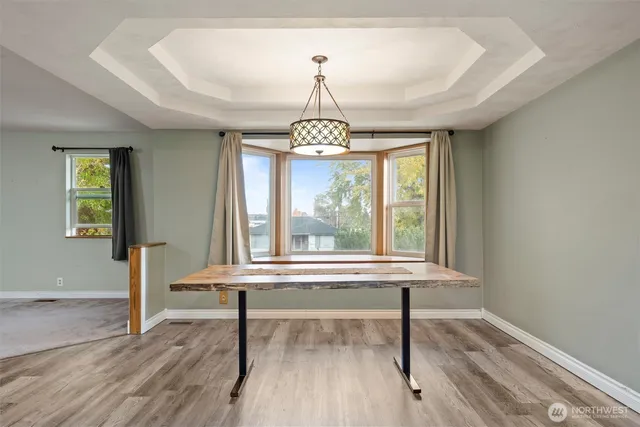 a view of entryway with wooden floor and windows
