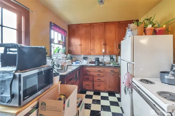 a kitchen with stainless steel appliances granite countertop a refrigerator and a stove top oven