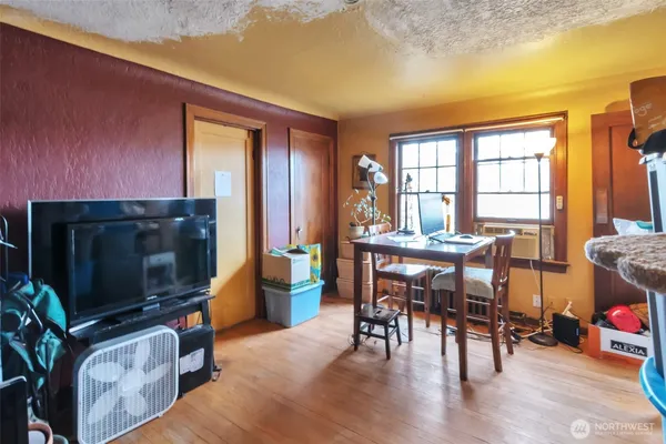 a living room with furniture a flat screen tv and floor to ceiling window