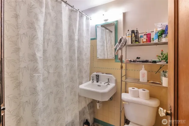 a bathroom with a sink mirror and toilet