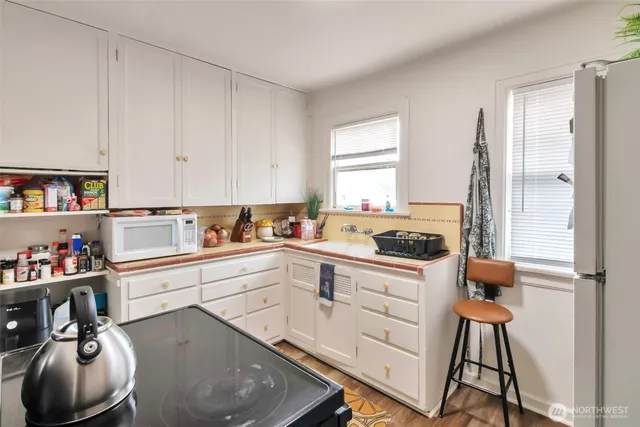 a kitchen with a sink cabinets and window