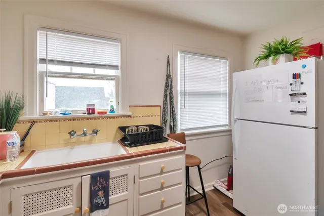 a kitchen with a refrigerator and a window