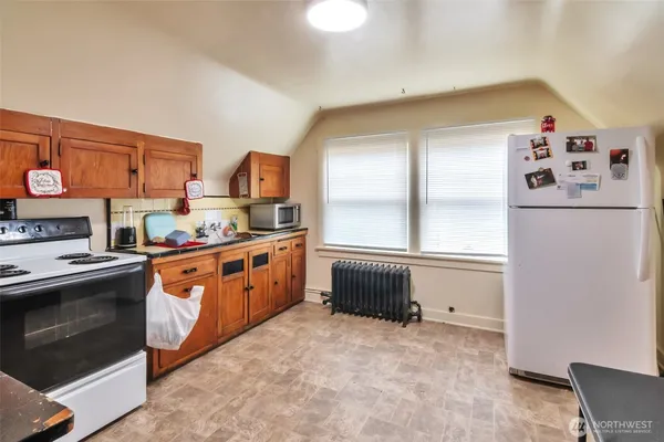 a kitchen with stainless steel appliances granite countertop a stove top oven a sink and cabinets