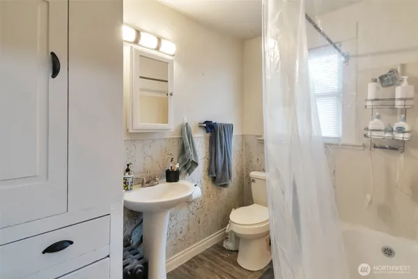 a bathroom with a toilet a sink and a bathtub