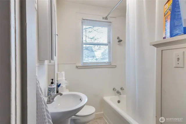 a bedroom with bed and a flat screen tv