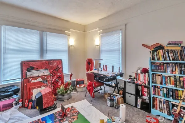 a view of a livingroom with wooden floor and a ceiling fan