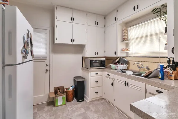 a kitchen with cabinets appliances and a window