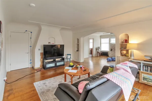 a living room with furniture and a wooden floor
