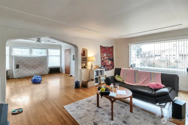 a living room with furniture a window and a flat screen tv